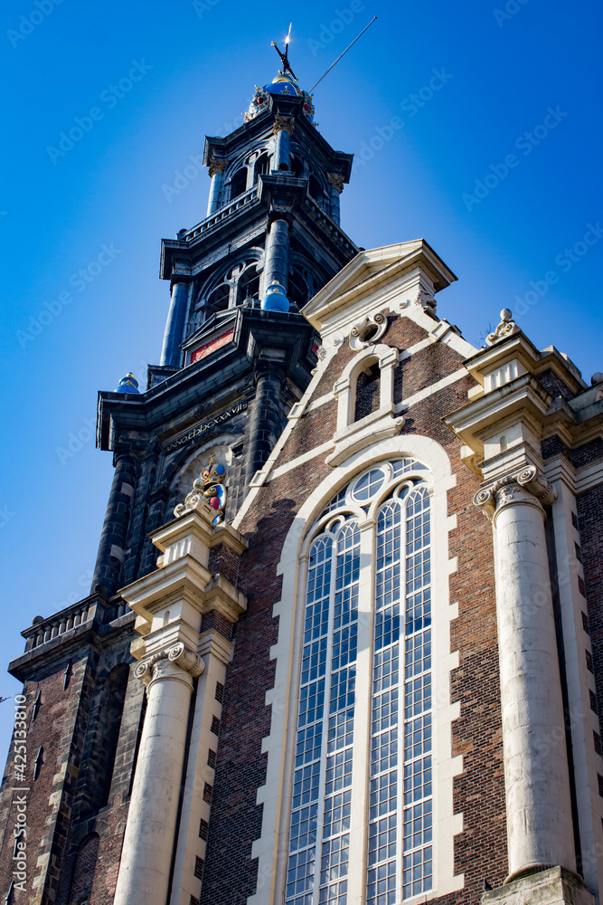 Looking up at the Famous Westerkerk Church from the Canals below in Amsterdam, Netherlands Looking up at the Famous Westerkerk Church from the Canals below in Amsterdam, Netherlands