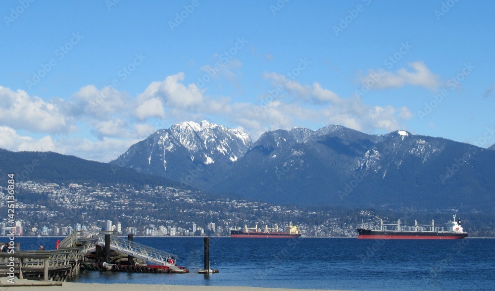 Beautiful Scenery Of Blue sky, mountain, and Cargo Ships At Vancouver Jericho Beach Beautiful Scenery Of Blue sky, mountain, and Cargo Ships At Vancouver Jericho Beach