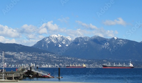 Beautiful Scenery Of Blue sky, mountain, and Cargo Ships At Vancouver Jericho Beach
