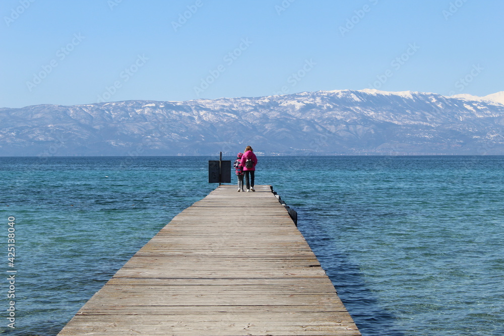 person walking on the pier person walking on the pier