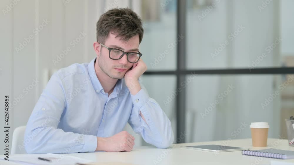 Young Man Taking Nap in Office 