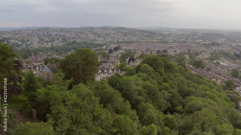 Wide aerial cityscape of residential houses overlooking lush green woodland in city of Bath, United Kingdom Wide aerial cityscape of residential houses overlooking lush green woodland in city of Bath, United Kingdom