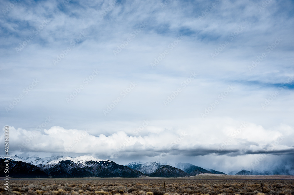 Dynamic Cumulus Clouds over Sangre de Cristo Mountain Range in Southern Colorado with Sage Brush Plains