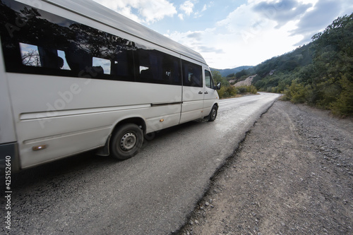 minibus moves on road in the mountains
