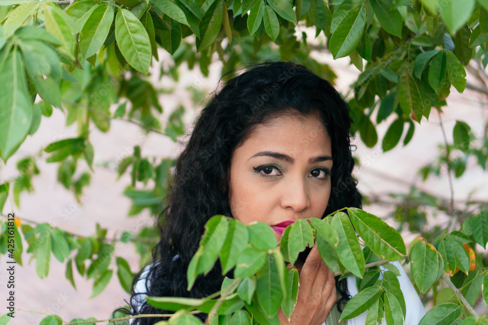 Colombian woman standing in the city, looking at the camera. Colombian woman standing in the city, looking at the camera.