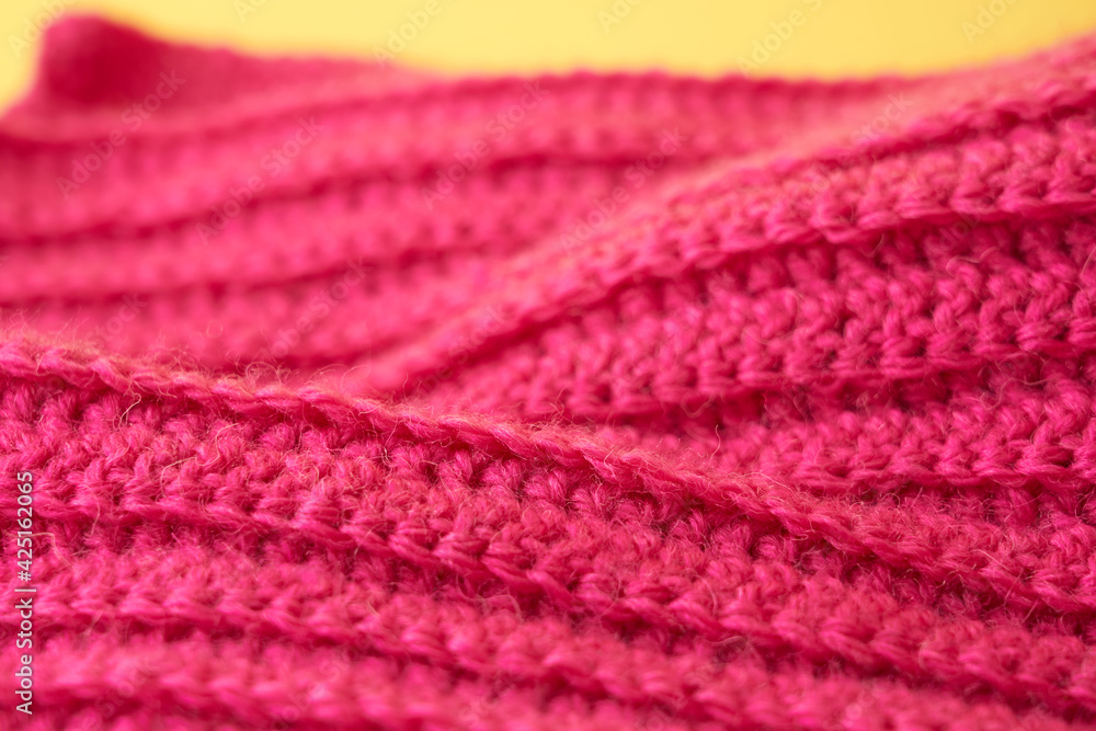 The hand-tied magenta-colored knitted canvas is like a background. The hand-tied magenta-colored knitted canvas is like a background.