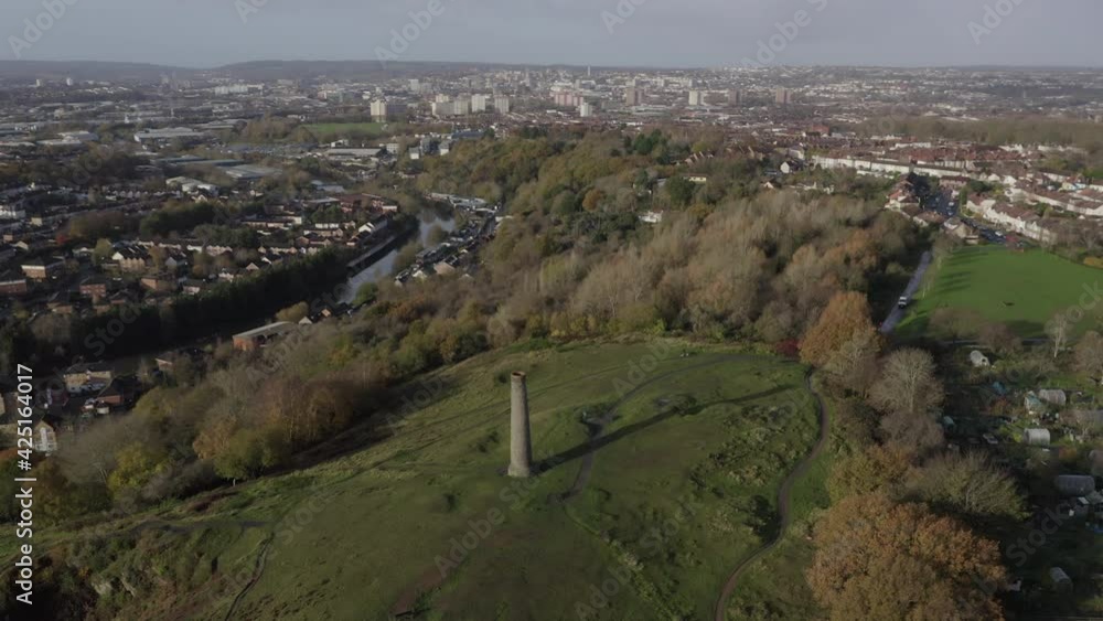Aerial shot tracking around stone chimney and Troopers Hill with Bristol city in the background Aerial shot tracking around stone chimney and Troopers Hill with Bristol city in the background