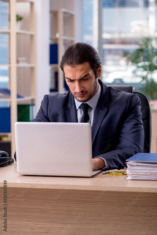 Young businessman employee working in the office Young businessman employee working in the office
