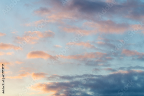 Blue sky day with pink textured, toned and colored clouds great for sky replacement with dramatic sky view. 