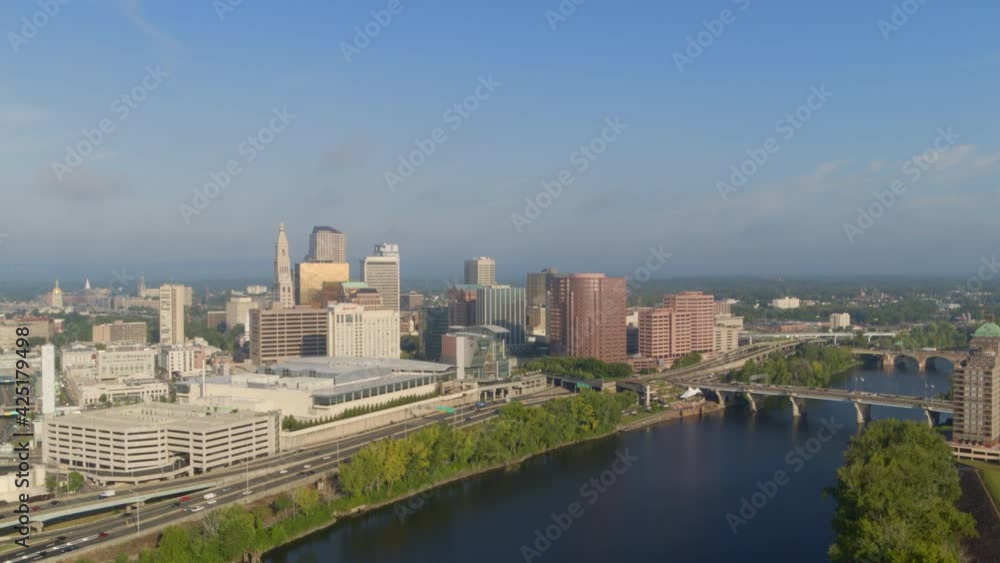 Aerial of busy street and high-rise buildings along river coast Aerial of busy street and high-rise buildings along river coast