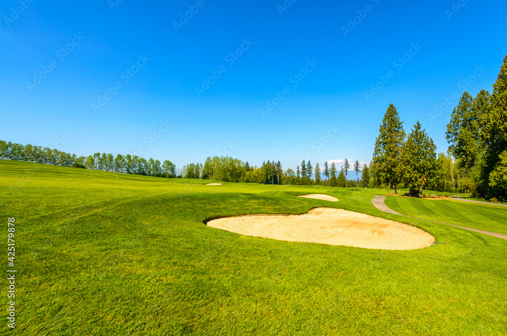 Golf course with gorgeous green and sand bunker