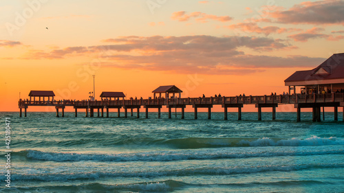 Fishing pier. Spring break or Summer vacations. Clearwater Beach Pier 60. Ocean or Gulf of Mexico. Florida paradise. Tropical nature. Beautiful ocean sunset. Good for travel agency.