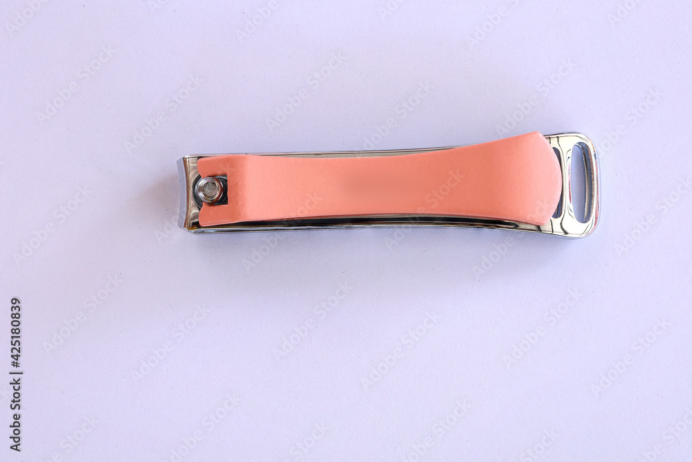 cutting nails made of metal with pink arm, Manicure nail clippers ,Isolated over white background cutting nails made of metal with pink arm, Manicure nail clippers ,Isolated over white background