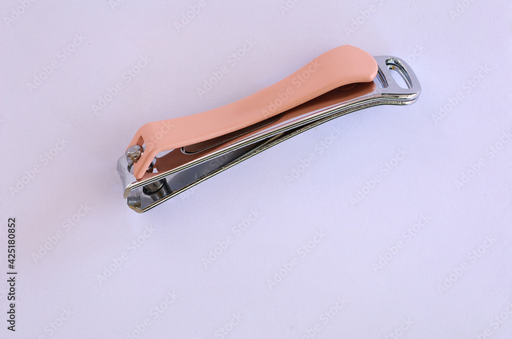 cutting nails made of metal with pink arm, Manicure nail clippers ,Isolated over white background cutting nails made of metal with pink arm, Manicure nail clippers ,Isolated over white background