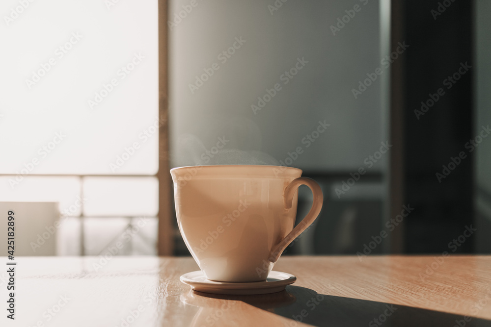 Hot cup of drink on the table in sun light of calm and warm morning. Hot cup of drink on the table in sun light of calm and warm morning.