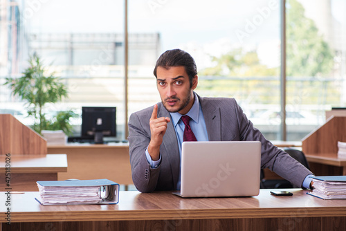 Young male employee working in the office