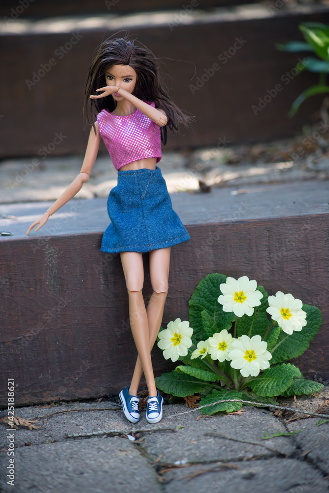 Mulhouse - France - 31 March 2021 - Portrait of brunette Barbie doll  wearing a blue jean's skirt standing in a public garden Stock Photo | Adobe  Stock