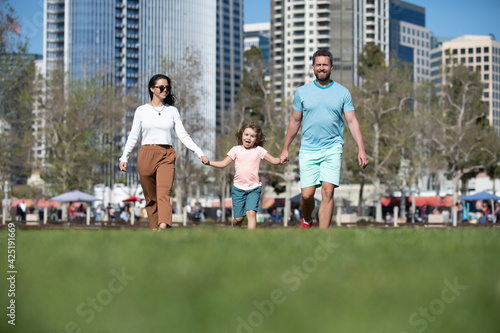 Family in the city. Family walking in urban park. Concept of children and parents, happy family.