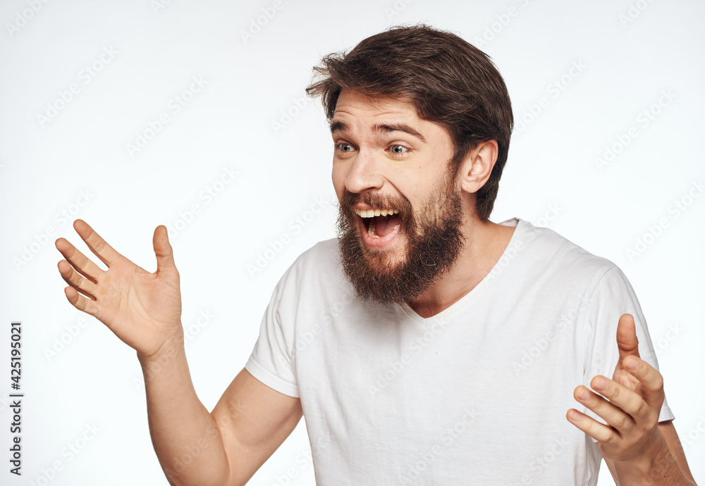 Emotional man on a light background gesturing with his hands cropped view Emotional man on a light background gesturing with his hands cropped view