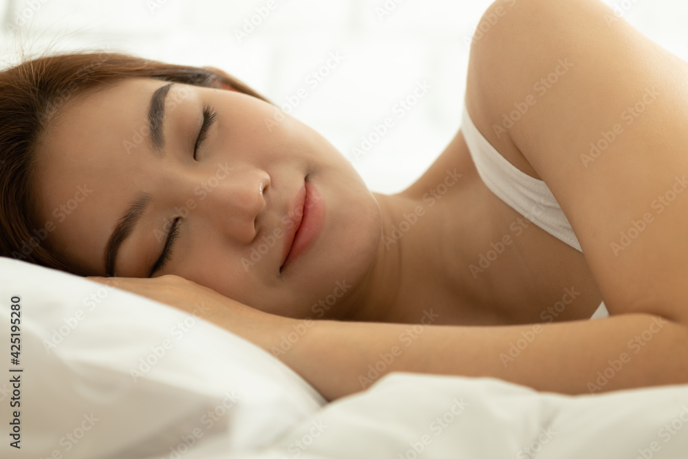Asian women sleeping and sweet dream on white bed in bedroom Asian women sleeping and sweet dream on white bed in bedroom
