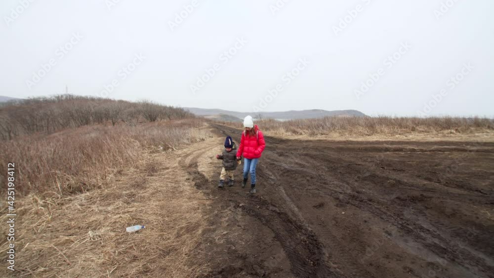 Sister and brother and walking along the muddy road. Spring Sister and brother and walking along the muddy road. Spring