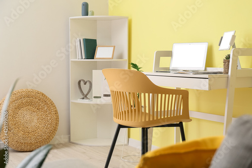 Stylish workplace with lapt...