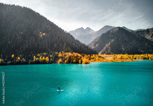 Wallpaper Mural Man on stand up paddle board at mountain lake Torontodigital.ca