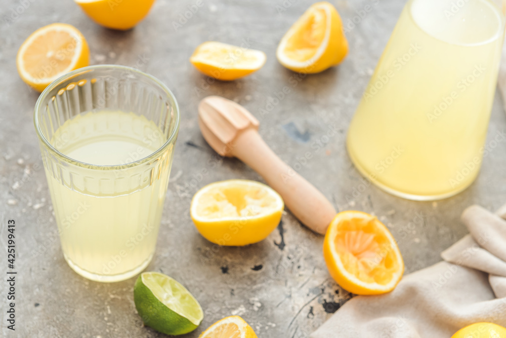 Fresh lemons and glass of juice on grunge background Fresh lemons and glass of juice on grunge background