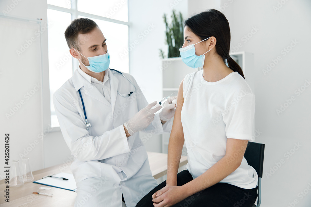 doctor in a lab coat and a protective mask syringe infection vaccine laboratory hospital hospital covid doctor in a lab coat and a protective mask syringe infection vaccine laboratory hospital hospital covid
