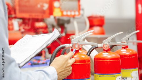 Engineer inspection Fire extinguisher and fire hose,Ready to use in the event of a fire.Safety first concept. photo