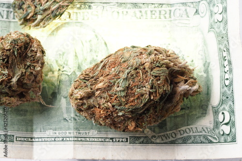 american dollars and cannabis medical marijuana business concept