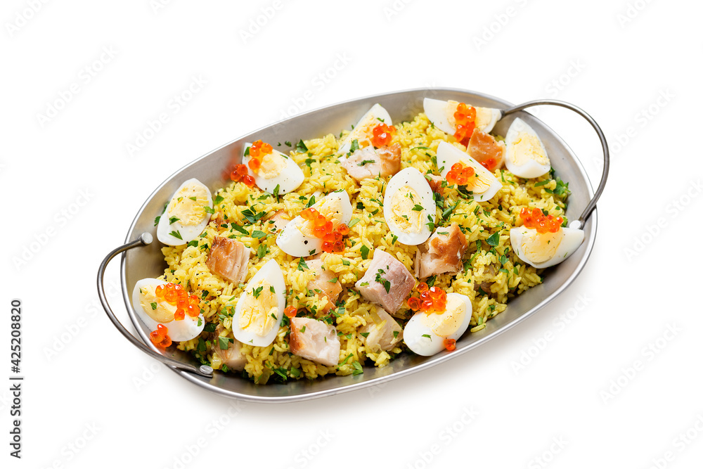 Traditional british cuisine. Fresh prepared kedgeree with smoked haddock and boiled egg. Served with fresh parsley and red caviar.  isolated on white background