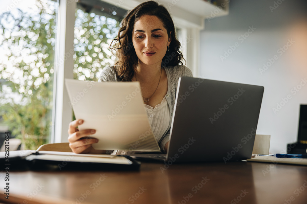 Woman reading some documents at home office Woman reading some documents at home office