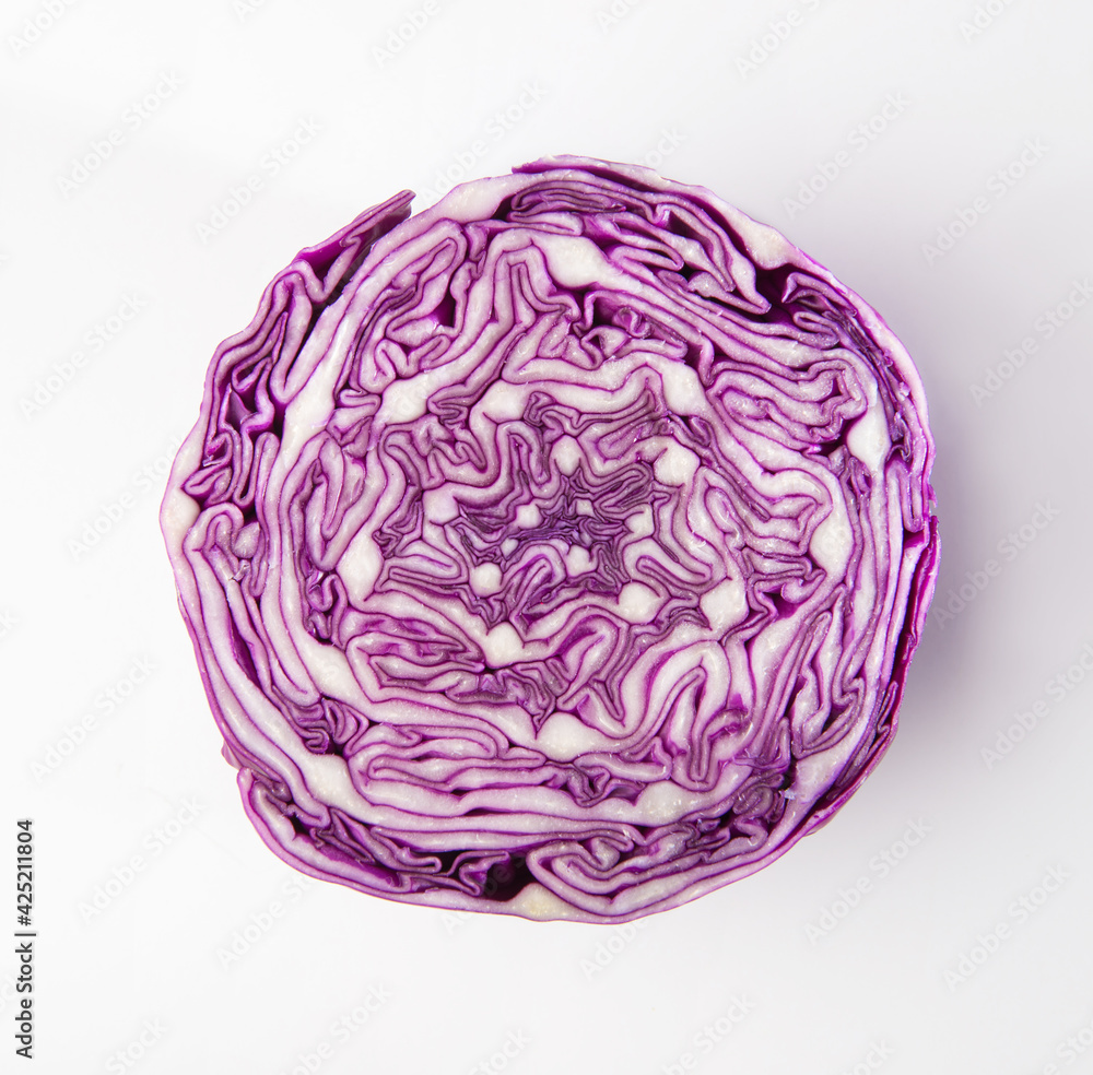 An isolated photo of sliced red cabbage from top. Close up of an intricate pattern of purple color cabbage after slicing it. Fresh vegetable cross section. An isolated photo of sliced red cabbage from top. Close up of an intricate pattern of purple color cabbage after slicing it. Fresh vegetable cross section.