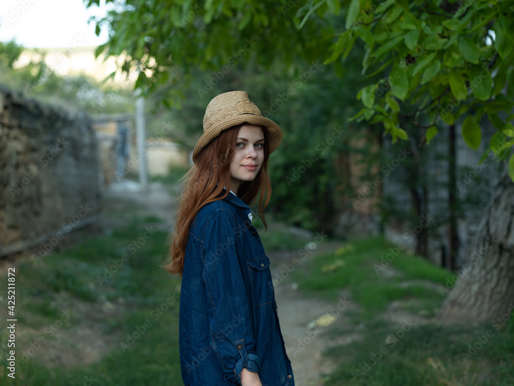 Woman with hat and denim jacket countryside nature building emotions