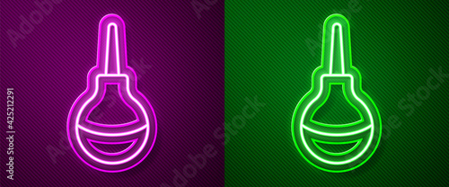 Glowing neon line Enema icon isolated on purple and green background. Enema with a plastic tip. Medical pear. Vector