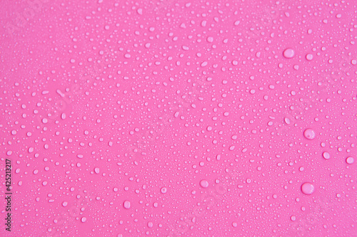 Full frame of the textures formed by the bubbles and drops of water. Drops of water spilled on a light pink surface © Мария Чичина