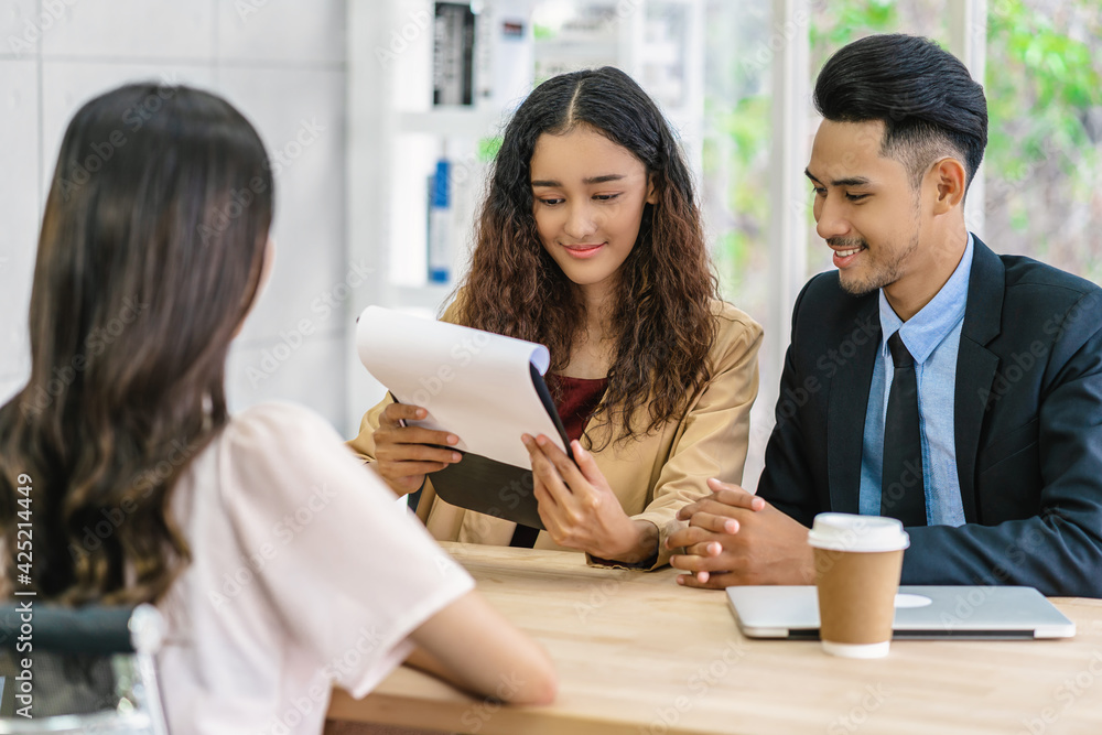 .Senior Asian Manager explaining or answering about job description and benefits to Young Asian woman graduate with positive motion in meeting room,Business Hiring new member concept
