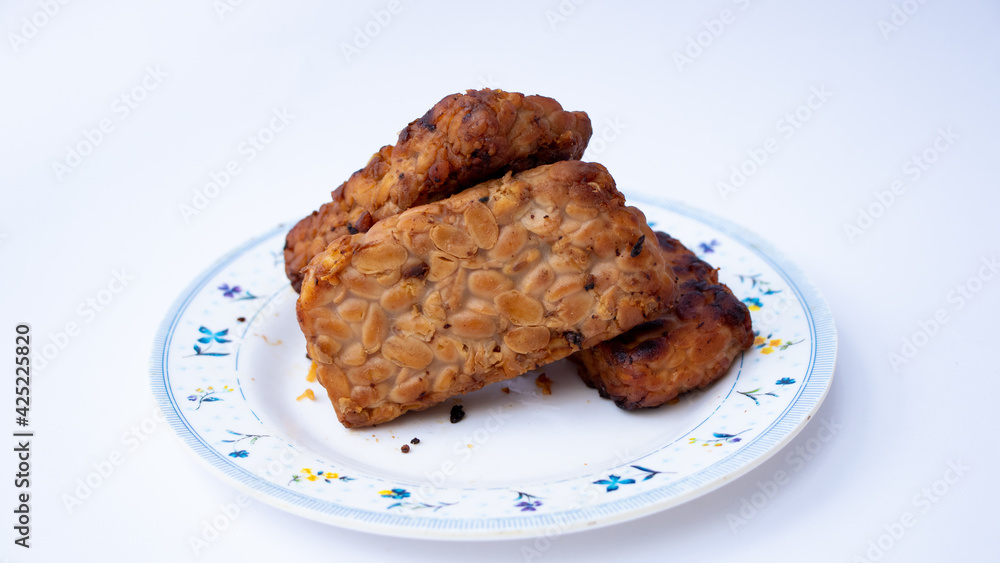 Close up of tempe bacem. Traditional foods from Java, Indonesia. Made from soya bean. isolated on white background 