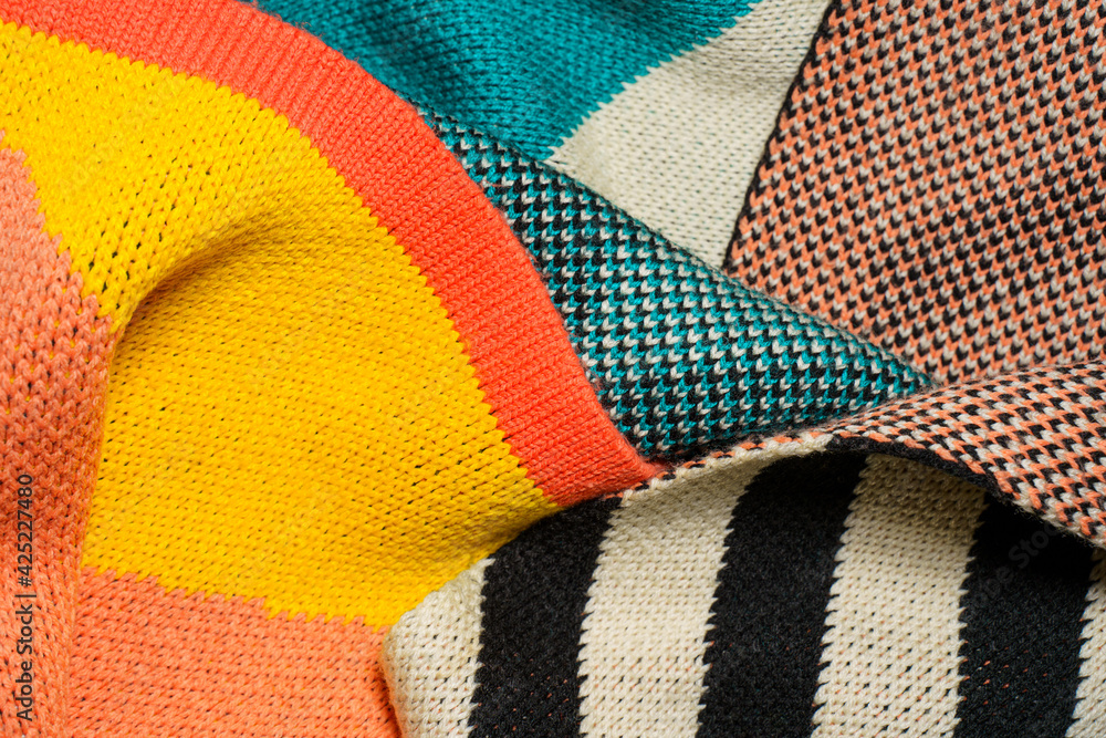 A pile of multi-colored knitted fabrics A pile of multi-colored knitted fabrics