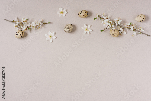Top view of the Happy Easter holiday background concept decoration arrangements.The apartment was a quail Easter egg with white flowers on a beige table
