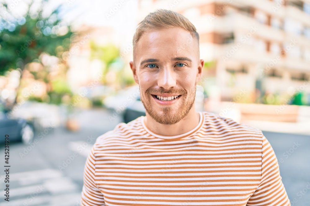 Young irish man smiling happy walking at street of city. Young irish man smiling happy walking at street of city.
