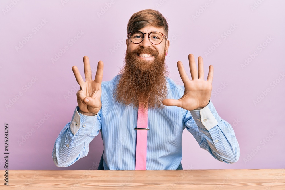 Young irish redhead man wearing business shirt and tie sitting on the table showing and pointing up with fingers number eight while smiling confident and happy. Young irish redhead man wearing business shirt and tie sitting on the table showing and pointing up with fingers number eight while smiling confident and happy.