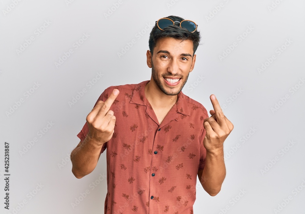 Fototapeta premium Young handsome man wearing casual summer clothes showing middle finger doing fuck you bad expression, provocation and rude attitude. screaming excited