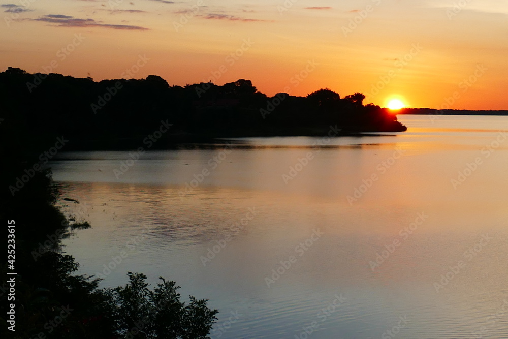 Tropical Amazon landscape, colorful sunset at the lake Mamori near Careiro in the amazon rainforest, state of Amazonas, Brazil.