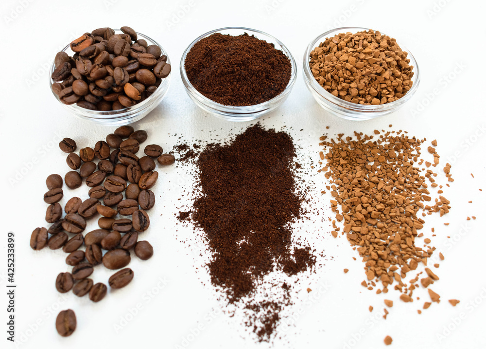Coffee beans ground and instant in glass bowls on a white background. View from above Coffee beans ground and instant in glass bowls on a white background. View from above