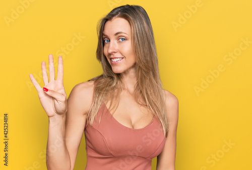 Beautiful caucasian woman wearing casual clothes showing and pointing up with fingers number four while smiling confident and happy.