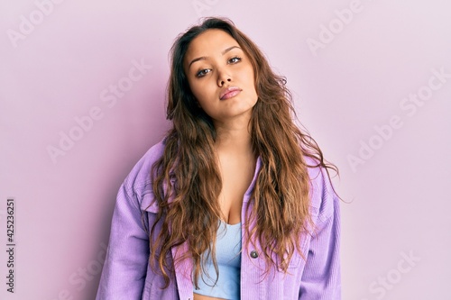 Young hispanic girl wearing casual clothes relaxed with serious expression on face. simple and natural looking at the camera. © Krakenimages.com