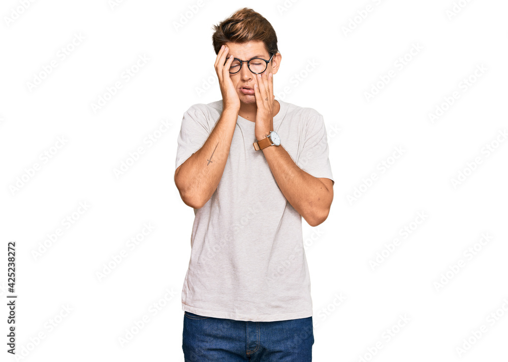 Fototapeta premium Handsome caucasian man wearing casual clothes and glasses tired hands covering face, depression and sadness, upset and irritated for problem