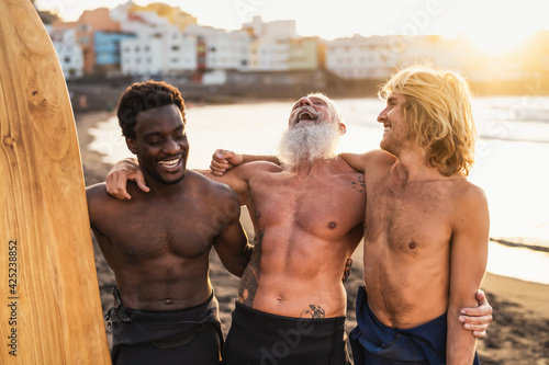 Photography Happy fit surfers with different age and race having fun surfing together at sun